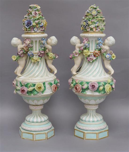 A pair of Dresden, Meissen style floral encrusted lidded vases, height 44cm (a.f.)